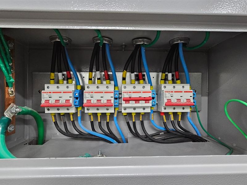 Disjuntores e cabos identificados em quadro elétrico avaliado no laudo elétrico da JETA Engenharia